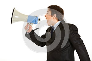 Frustrated businessman yelling through megaphone