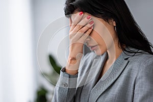 Frustrated businesswoman with bruise on hand