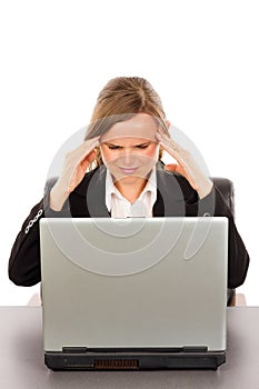 Frustrated businesswoman with headache sitting at office desk