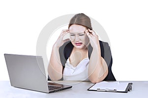 Frustrated businesswoman holds her head
