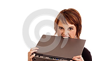 Frustrated Caucasian businesswoman biting laptop