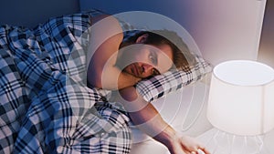 Frustrated caucasian man having sleeping problems. Noisy neighbours problem photo