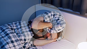 Frustrated caucasian man having sleeping problems. Noisy neighbours problem photo