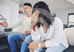 Frustrated couple, headache and fight in divorce, conflict or disagreement on living room sofa at home. Unhappy man and