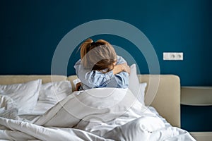 Frustrated depressed female feels broken cope with anxiety stressed sit in closed pose on home bed