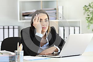 Frustrated executive looking at camera at office