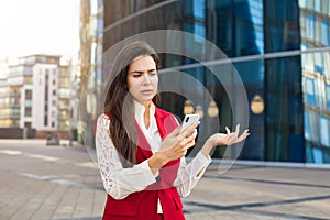 Frustrated female manager having online video conference via cell telephone