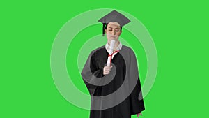 Frustrated female student in graduation robe shaking her diploma while waiting on a Green Screen, Chroma Key.
