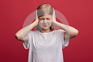 Frustrated girl with closed eyes tries not to listen to her parents` scandal