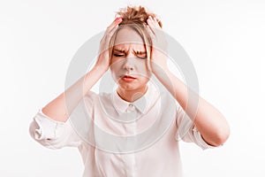Frustrated girl suffering from head ache. Upset young woman with pain grimace holding head. Headache or loss concept