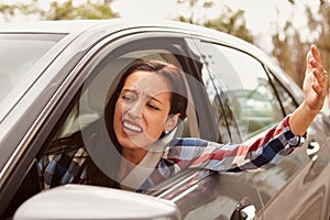 Frustrated Hispanic female driver in a car