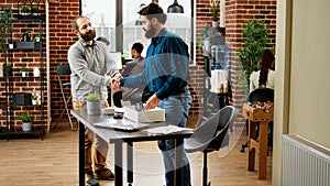 Frustrated jobless man getting fired from work and packing belongings in box