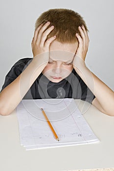 Frustrated little boy doing homeword