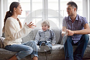 Frustrated little kid boy scared with mom and dad fighting