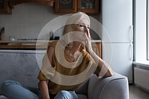 Frustrated lonely mature 50s woman looking away