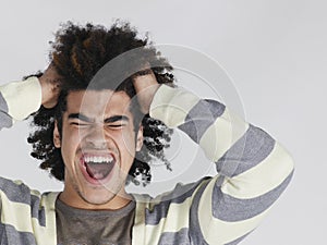 Frustrated Man With Afro Hairdo Pulling Hair photo