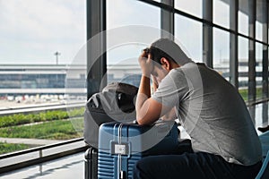 Frustrated man at the airport, annoyed because his flight was canceled.