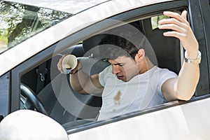 Frustrated Man in Car with Spilled Coffee on Shirt