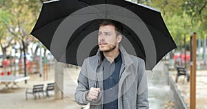 Frustrated man complaining about bad weather