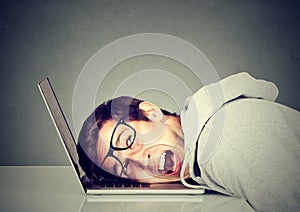 Frustrated man feeling stressed with his laptop computer