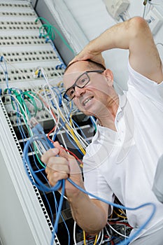 frustrated man holding cables