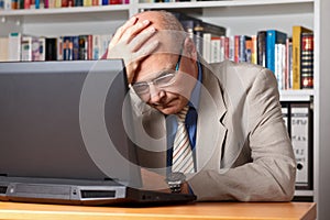 Frustrated man with laptop