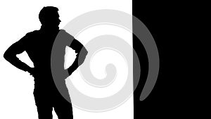 Frustrated man leaning against wall. White background. Silhouette