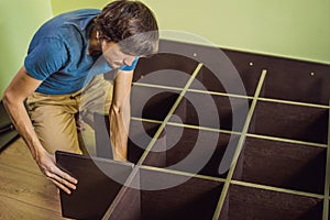 Frustrated Man Putting Together Self Assembly Furniture