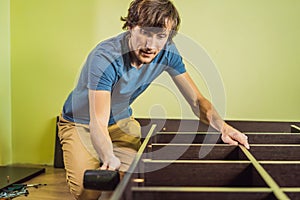 Frustrated Man Putting Together Self Assembly Furniture