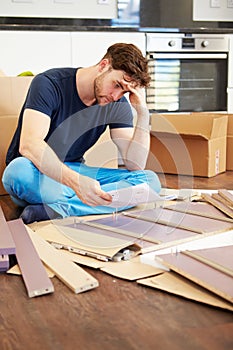 Frustrated Man Putting Together Self Assembly Furniture