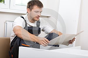 Frustrated man reading instruction