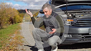 Frustrated man on road with broken car. Transportation, traveling concept