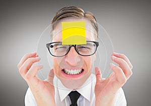 Frustrated man with sticky note on his forehead