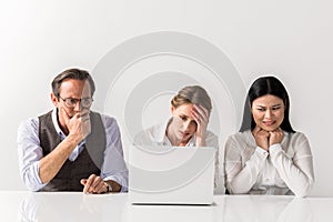 Frustrated man and women working on gadget