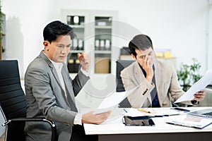 Frustrated manager scolds employee in office over financial error. Concept of workplace stress, reporting issues, conflict