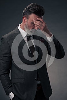 Frustrated middle aged elegant man Close up face of stressed businessman wearing stylish suit with eyes closed