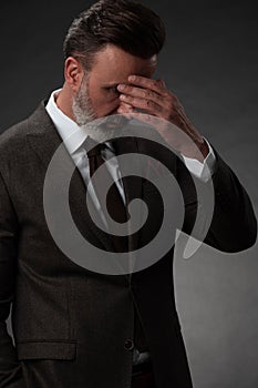 Frustrated middle aged elegant man Close up face of stressed businessman wearing stylish suit with eyes closed