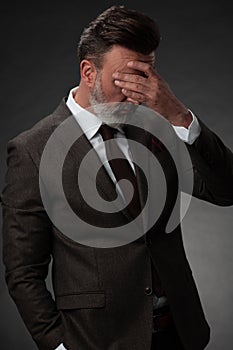 Frustrated middle aged elegant man Close up face of stressed businessman wearing stylish suit with eyes closed