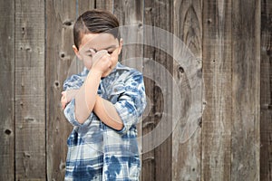 Frustrated Mixed Race Boy With Hand on Face