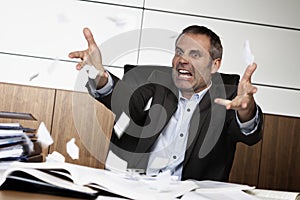 Frustrated office manager tearing document.