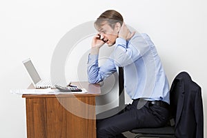 Frustrated office worker on the phone. holding