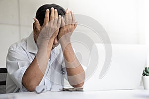 Frustrated old asian man sitting in front of laptop feeling depress working.