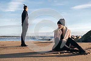 Frustrated sad girlfriend sit on sand think of relationship problems.