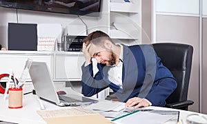 Frustrated sales manager working on laptop