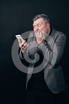 Frustrated scared man with smart phone
