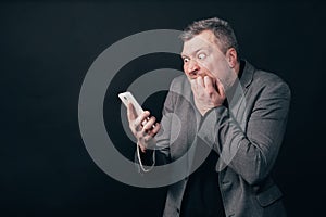 Frustrated scared man with smart phone