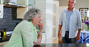 Frustrated senior man shouting on woman in kitchen 4k