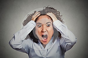 Frustrated shocked business woman pulling hair out yelling photo