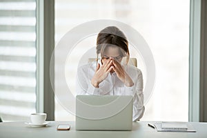 Frustrated stressed businesswoman feeling shock sitting in offic