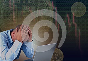 Frustrated stressed failed business man sitting with laptop with financial market chart graphic going down. Poor economy concept.